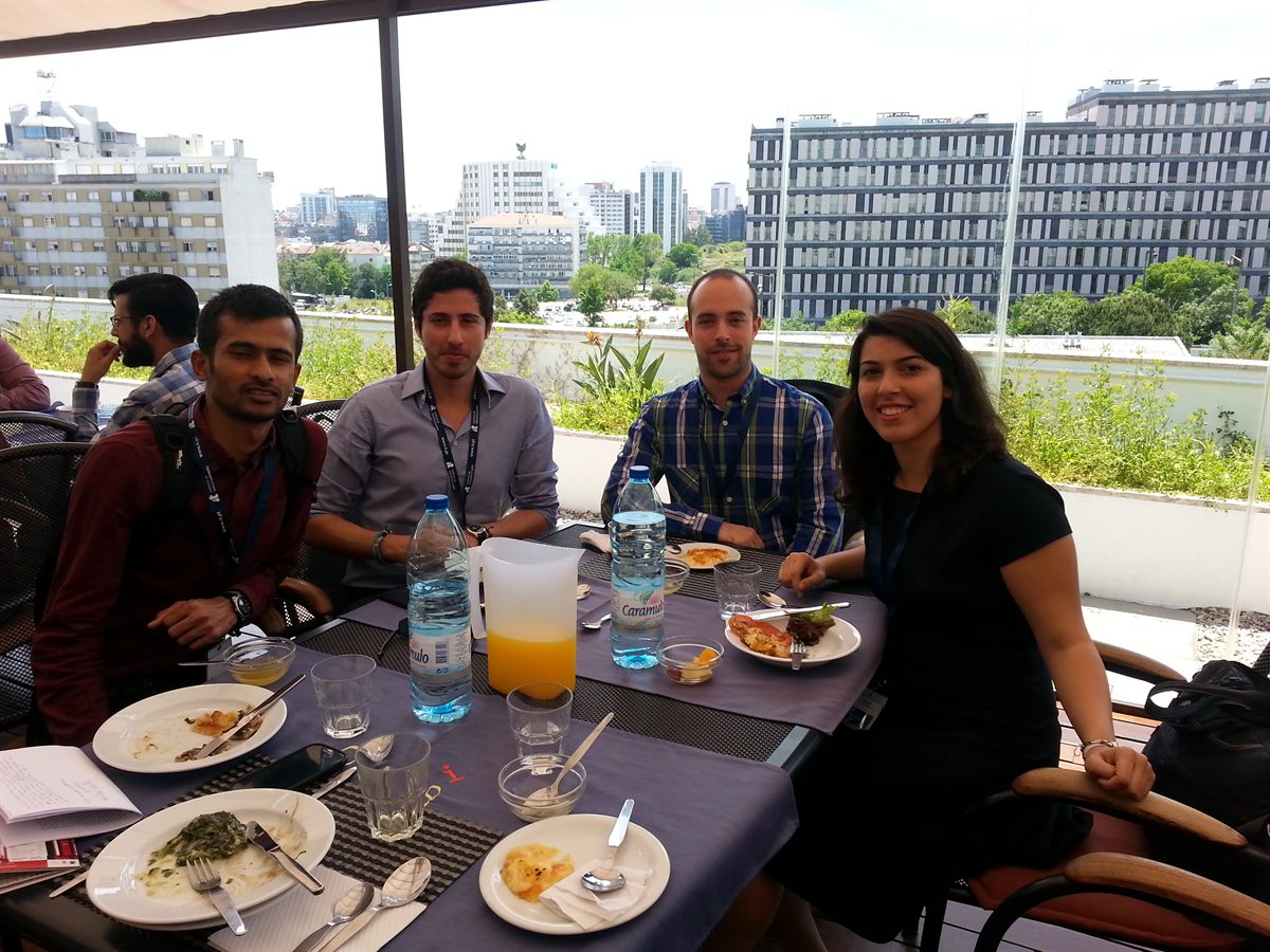 Colleagues having lunch on a sunny terrace