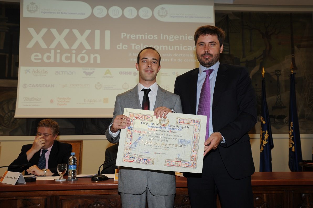 Receiving an award diploma on stage at the telecommunication engineering awards